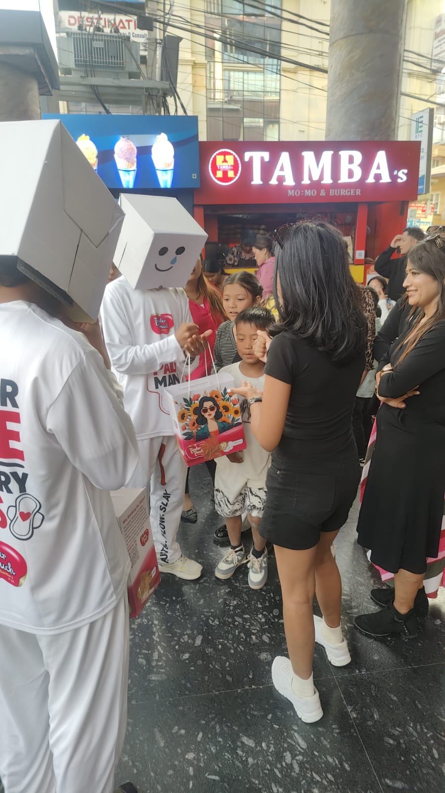 A PadMan ambassador playing Rock Paper Scissors with a campaign participant