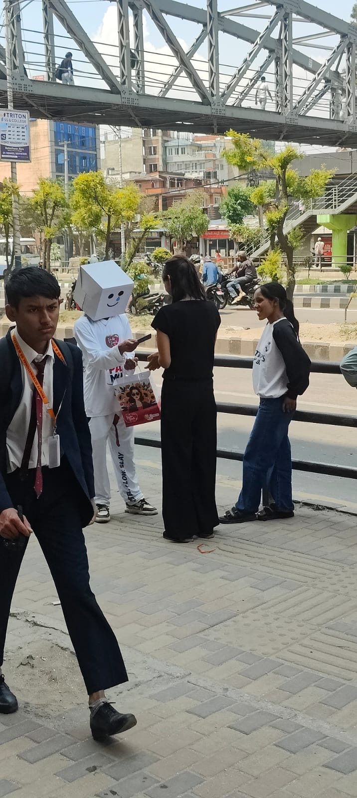A PadMan ambassador speaking with consumers beside a Kathmandu street